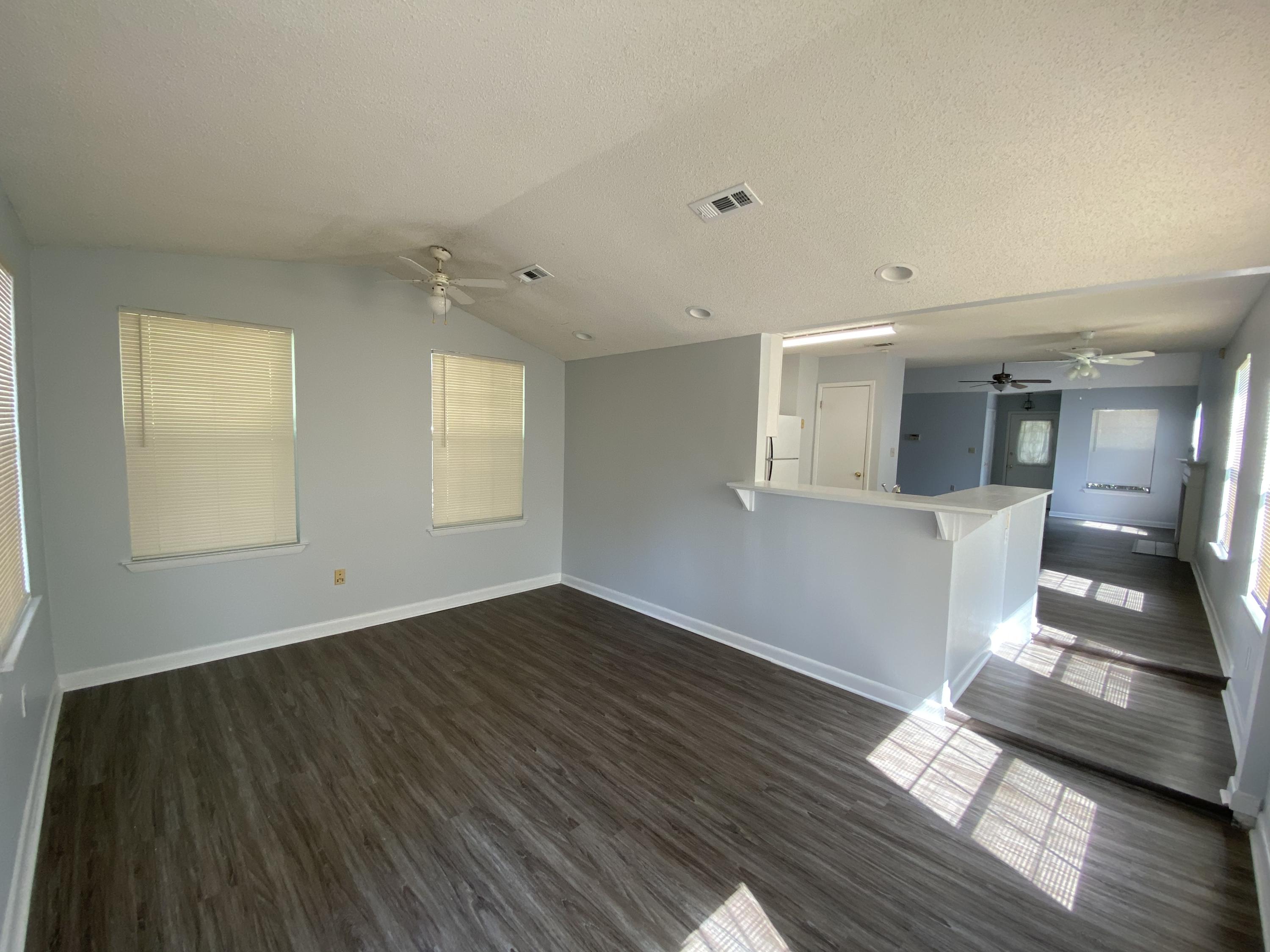 169 Wright Circle Niceville, FL 32578 - Photo 8 of 27 an empty room with wooden floor and windows