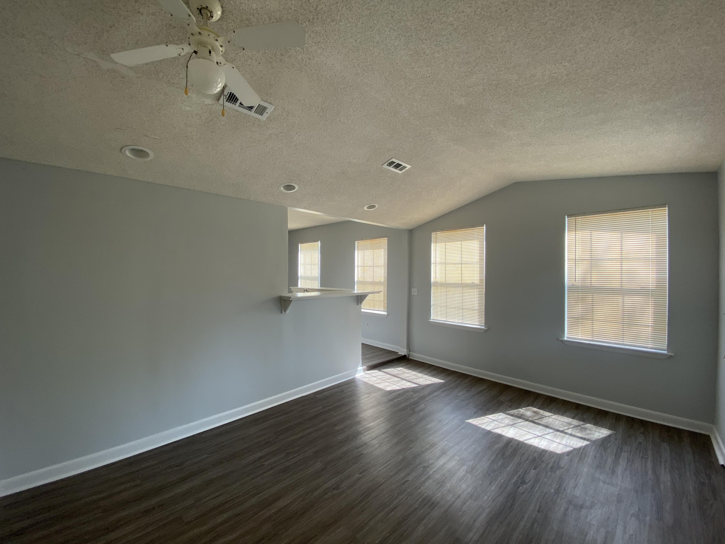 169 Wright Circle Niceville, FL 32578 - Photo 9 of 27 an empty room with wooden floor and windows