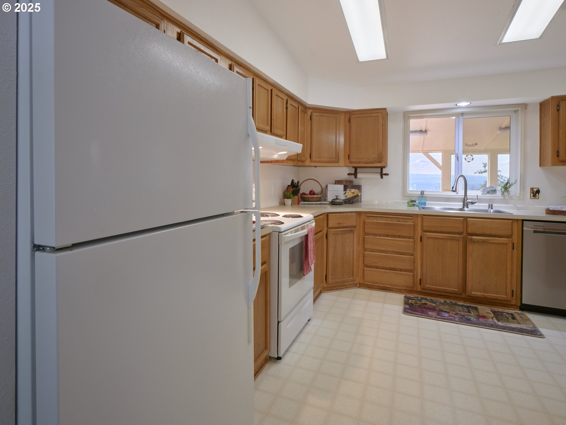 5389 Green Mountain Road Woodland, WA 98674 - Photo 22 of 47 a kitchen with a sink a refrigerator and cabinets