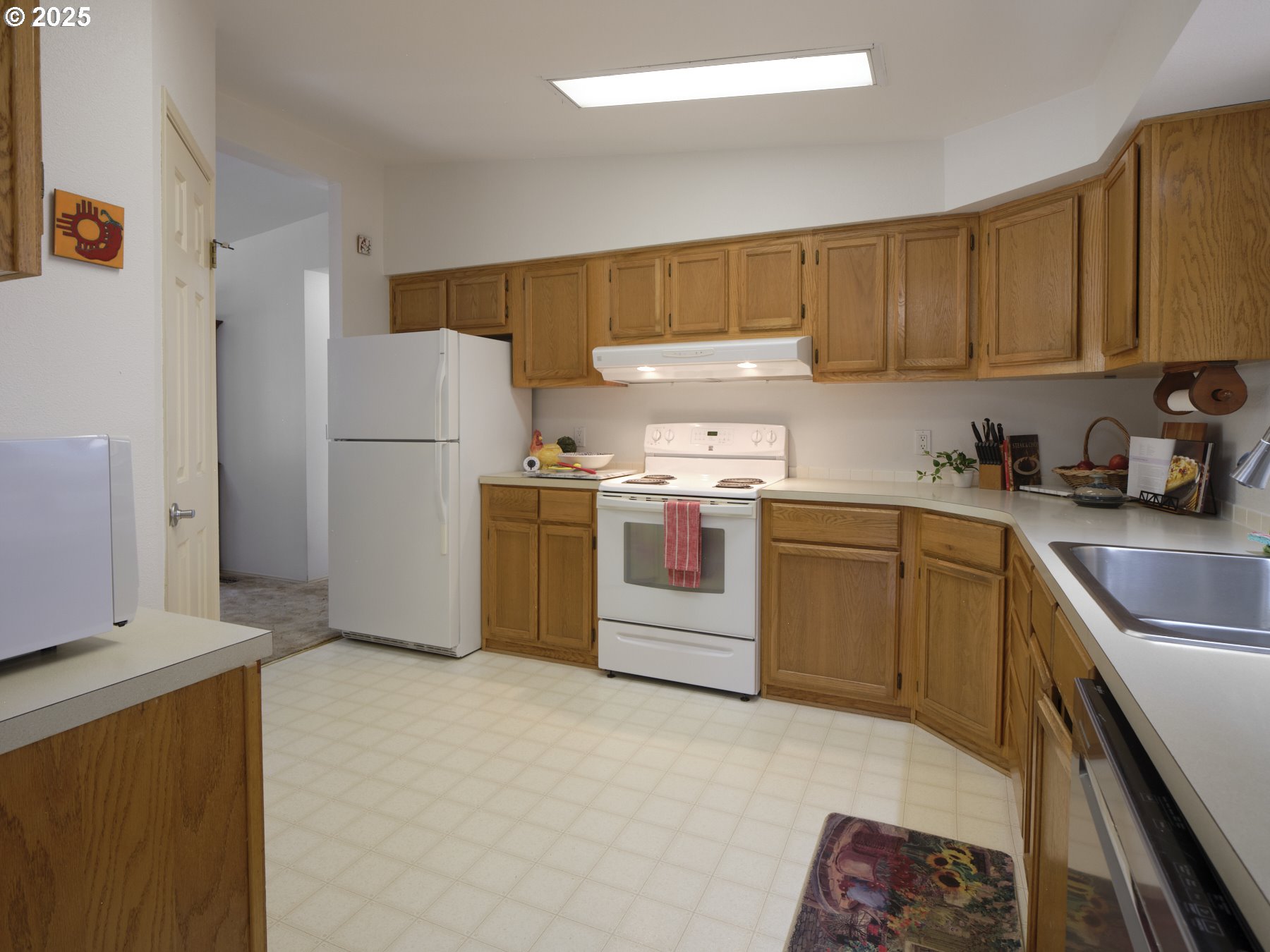 5389 Green Mountain Road Woodland, WA 98674 - Photo 23 of 47 a kitchen with a refrigerator sink and cabinets