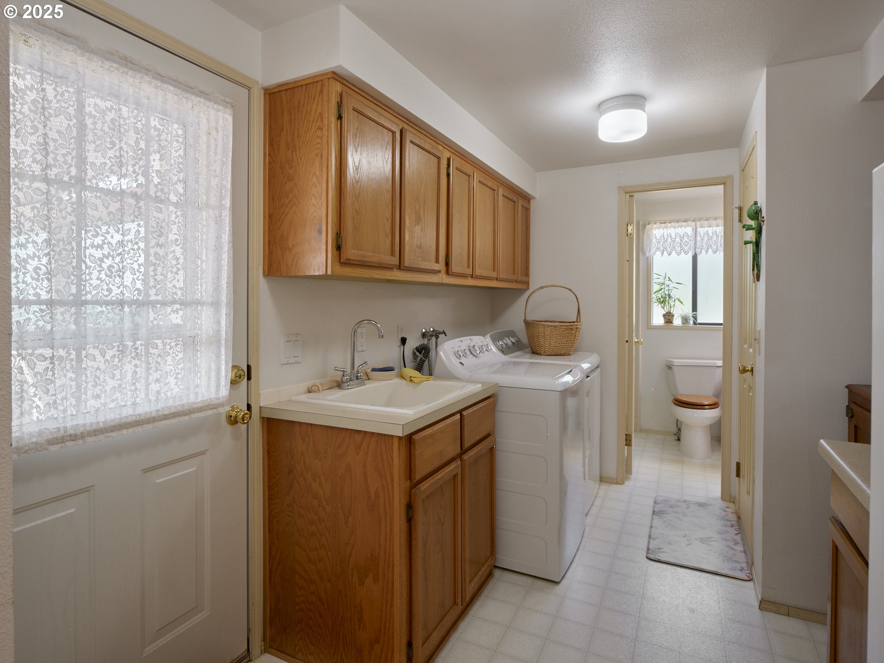 5389 Green Mountain Road Woodland, WA 98674 - Photo 26 of 47 a utility room with a sink a washer and dryer next to a window