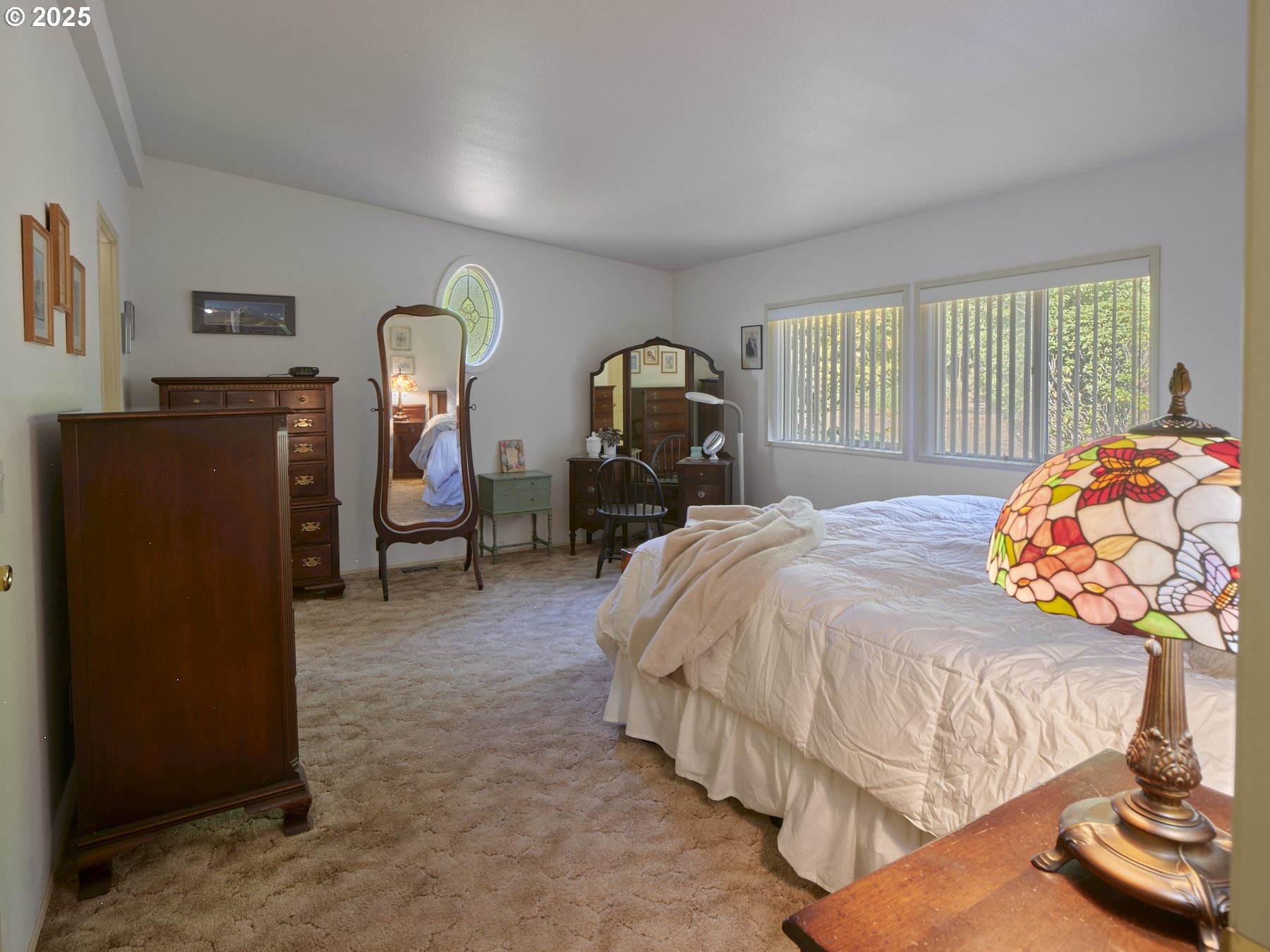5389 Green Mountain Road Woodland, WA 98674 - Photo 28 of 47 a bedroom with a bed and a chandelier