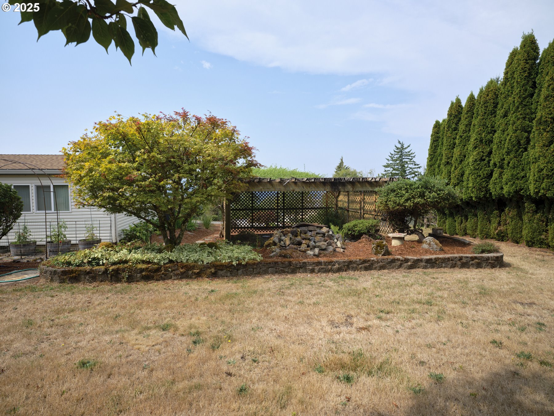 5389 Green Mountain Road Woodland, WA 98674 - Photo 39 of 47 a view of a backyard with plants and a lake