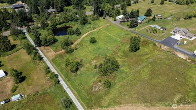 an aerial view of a residential houses with outdoor space