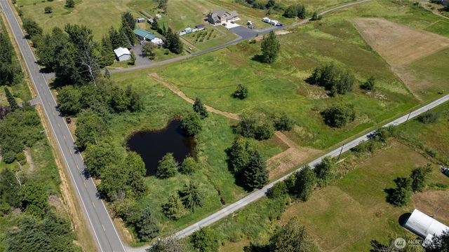 an aerial view of a residential houses with outdoor space