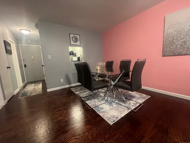 a living room with furniture rug and wooden floor