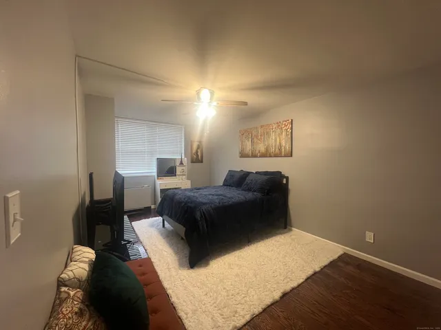 a bedroom with a bed window and a desk