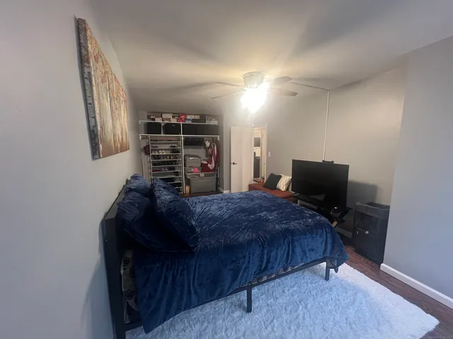 a view of walk in closet with clothes and shoes