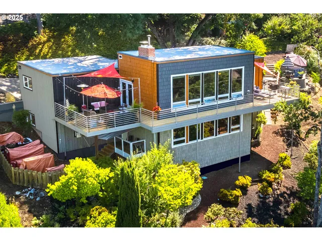 a view of a house with swimming pool and sitting area