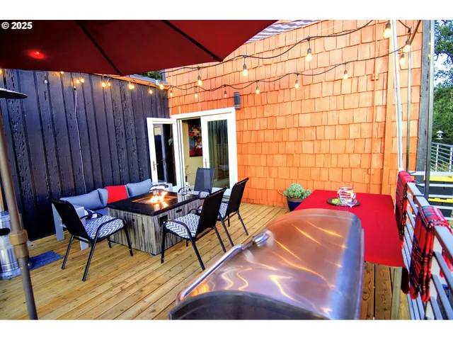 a outdoor sitting area with furniture and wooden floor