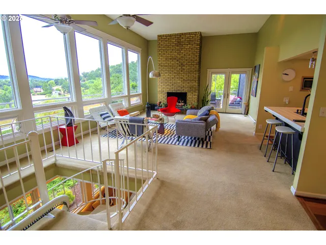 a living room filled with furniture and a floor to ceiling window