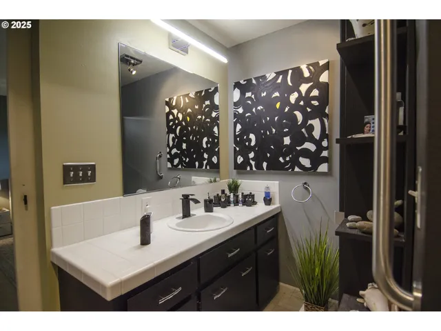 a bathroom with a sink vanity and a mirror