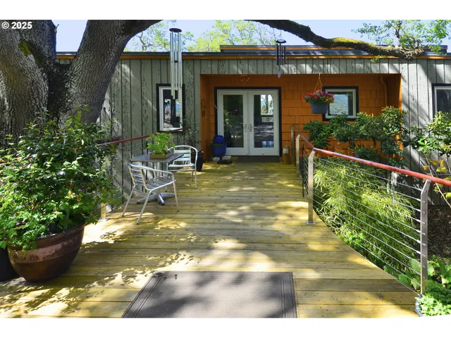 a view of a house with many windows next to a yard