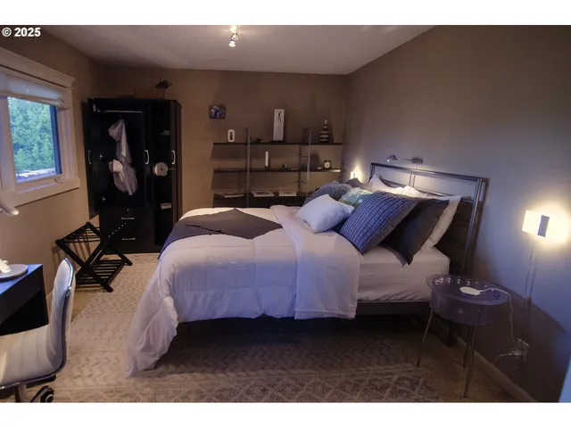 a bedroom with a bed window and wall painting