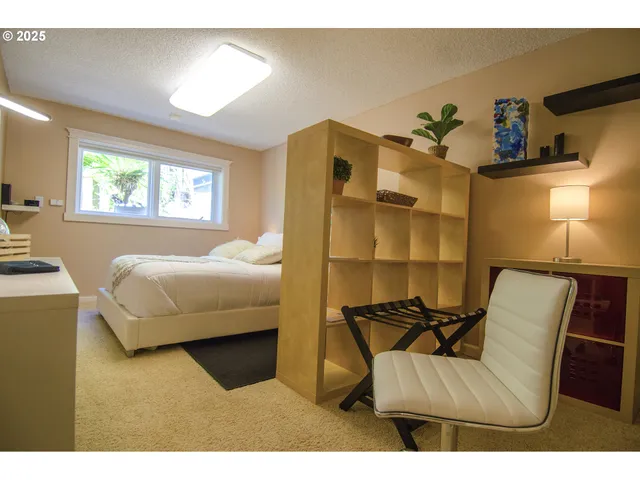 a bedroom with furniture and a window