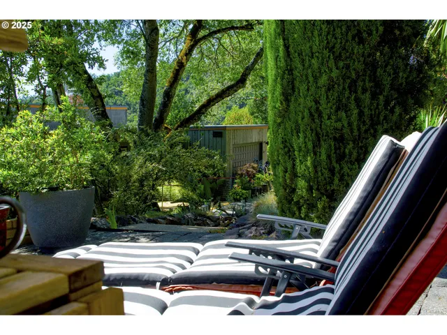 a view of backyard with swimming pool and outdoor seating