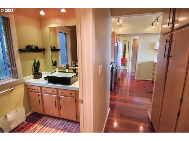 a bathroom with a sink a mirror and a shower