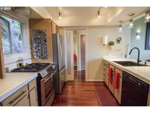 a kitchen with granite countertop a sink stove and cabinets
