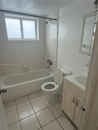 a bathroom with a sink a toilet and a bathtub