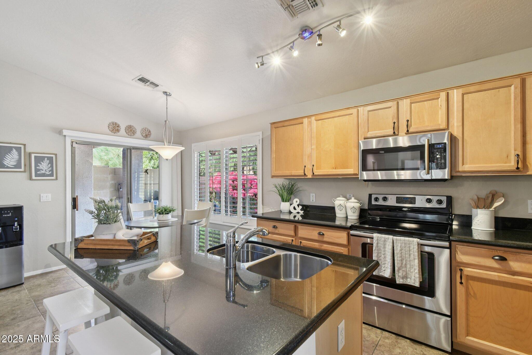 2250 East Deer Valley Drive, Unit 109 Phoenix, AZ 85024 - Photo 14 of 20 a kitchen with counter top space a sink and appliances