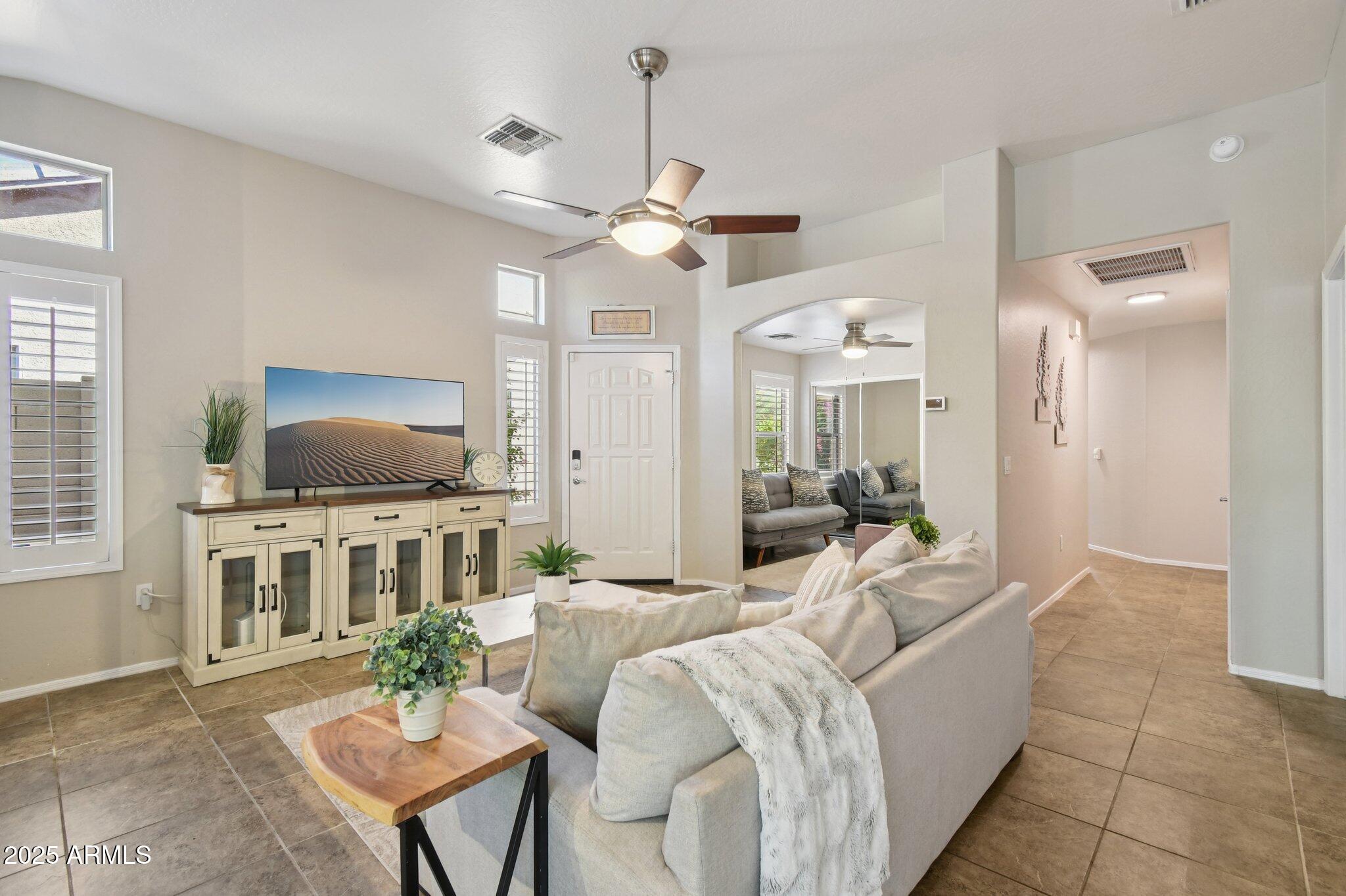2250 East Deer Valley Drive, Unit 109 Phoenix, AZ 85024 - Photo 18 of 20 a living room with furniture and a flat screen tv
