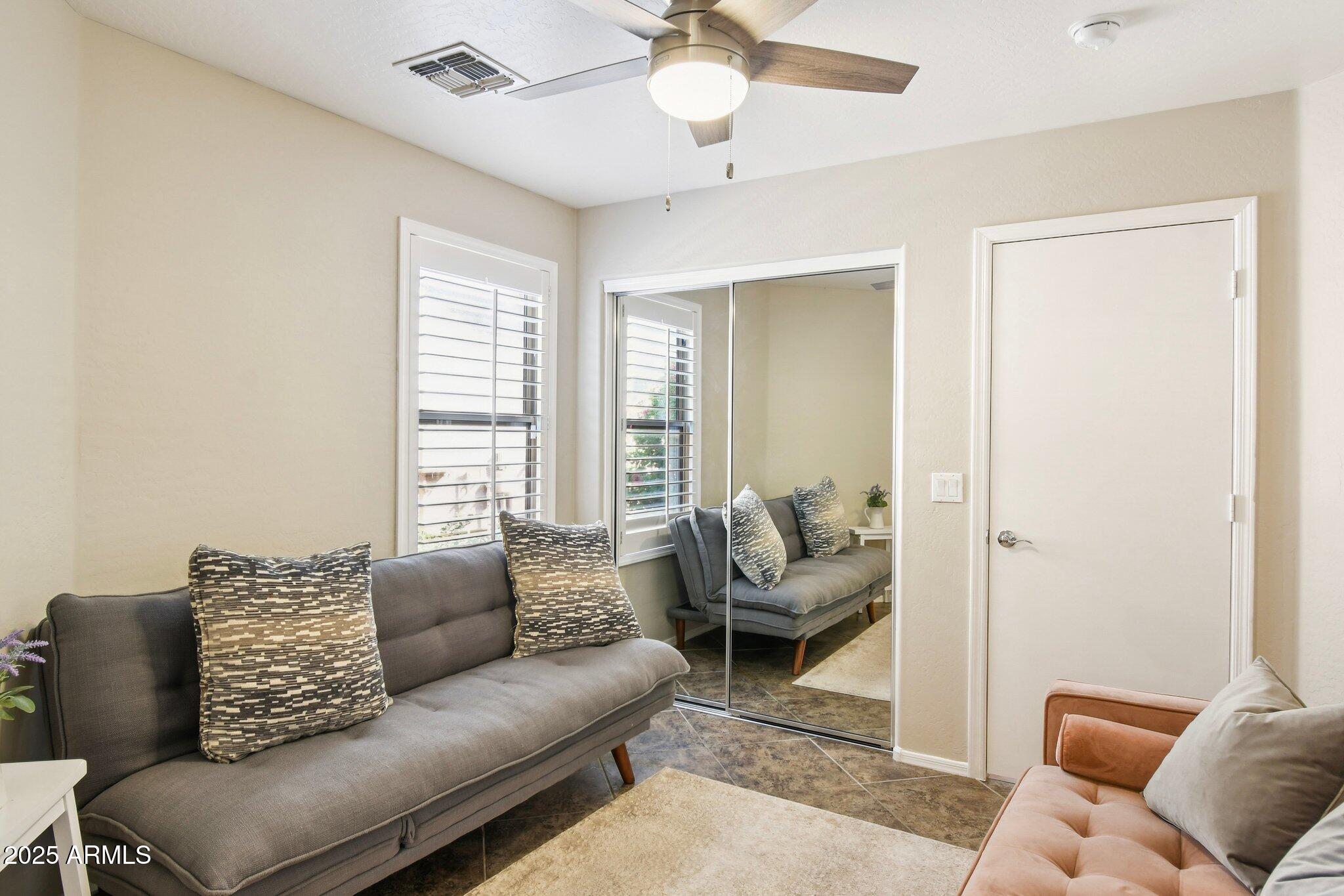 2250 East Deer Valley Drive, Unit 109 Phoenix, AZ 85024 - Photo 19 of 20 a living room with furniture and a large window