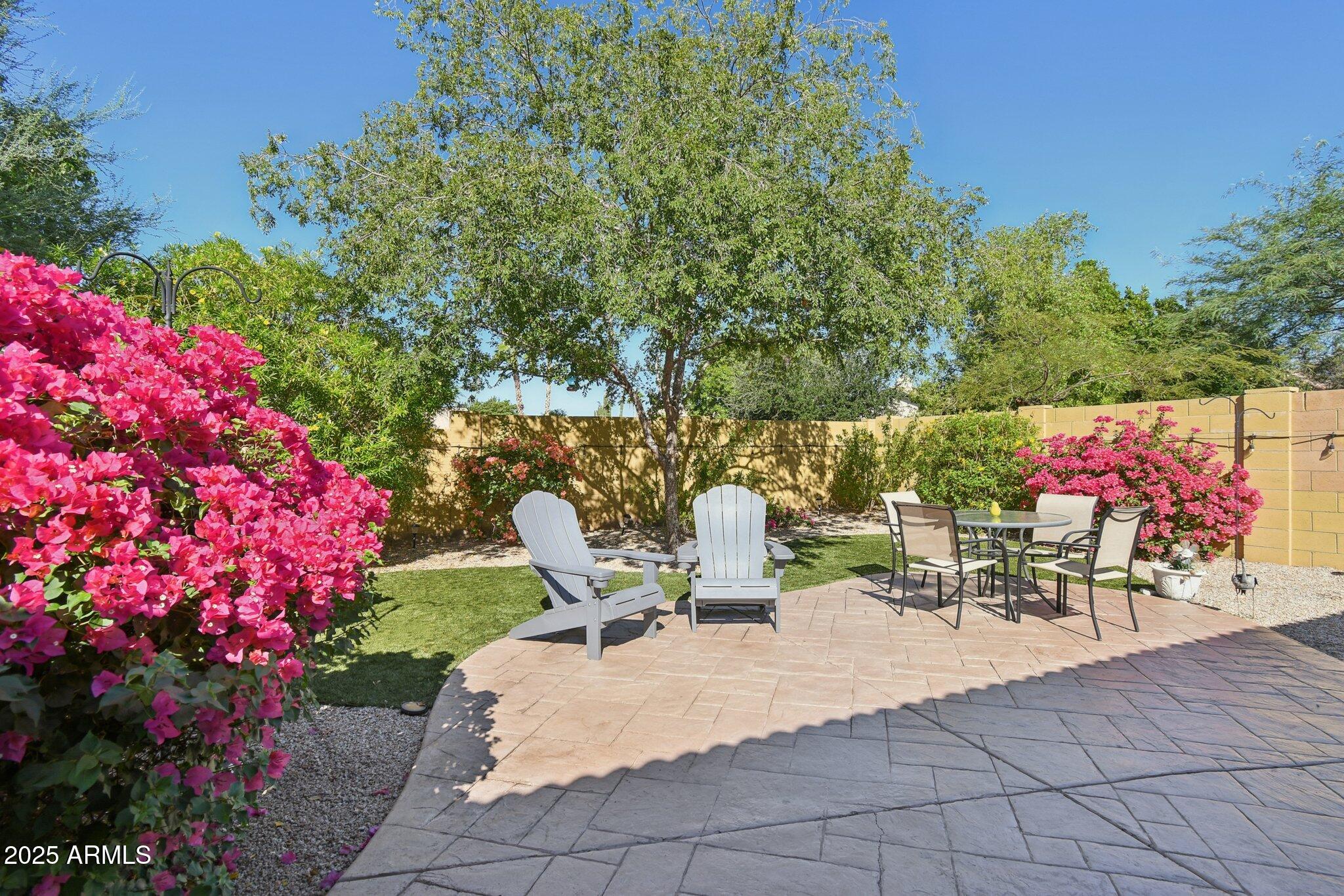 2250 East Deer Valley Drive, Unit 109 Phoenix, AZ 85024 - Photo 2 of 20 a view of a patio with table and chairs and potted plants