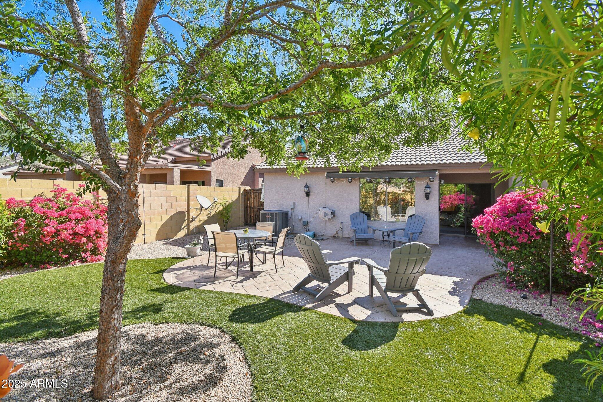 2250 East Deer Valley Drive, Unit 109 Phoenix, AZ 85024 - Photo 3 of 20 a view of a chairs and table in backyard