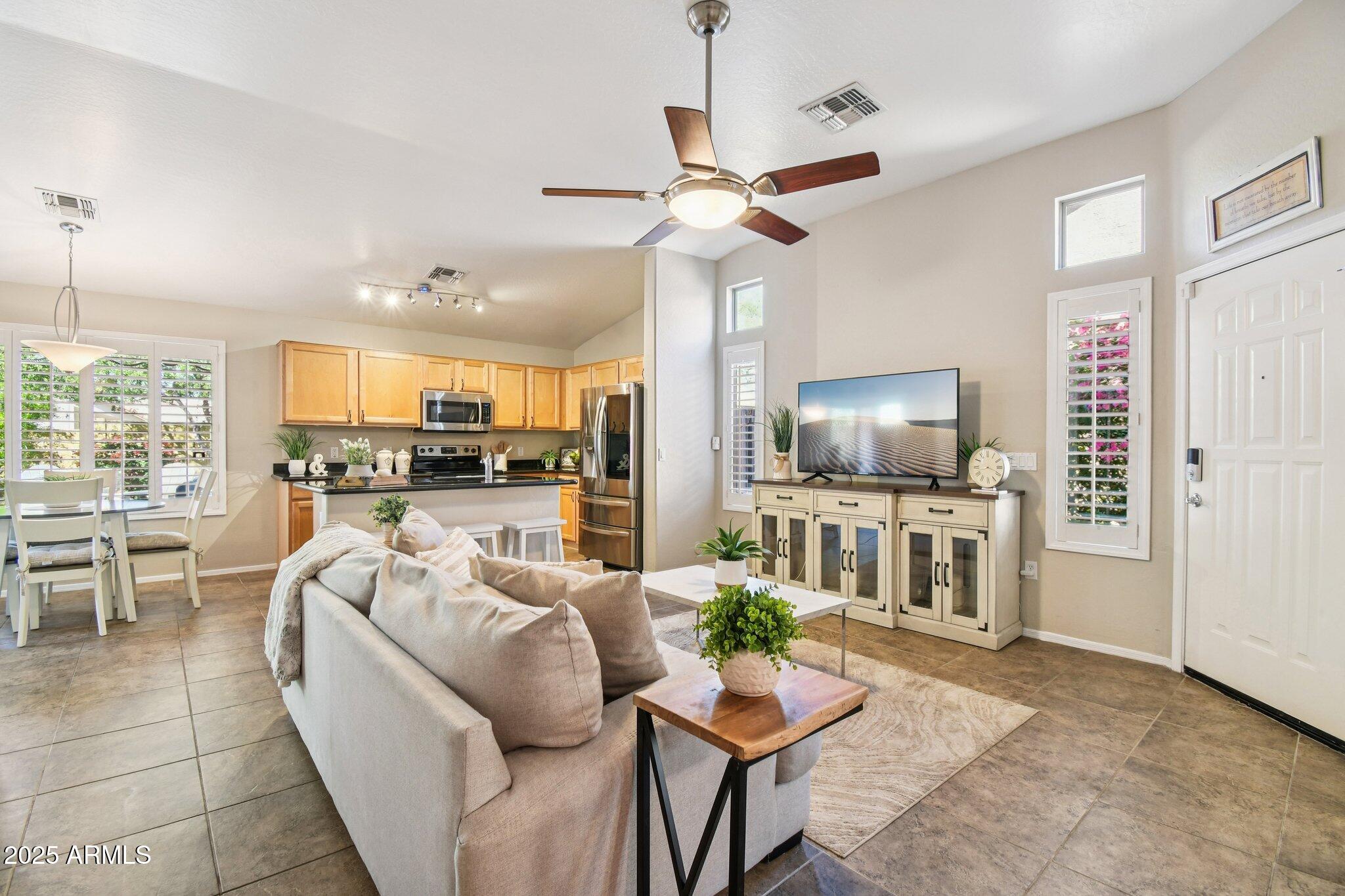 2250 East Deer Valley Drive, Unit 109 Phoenix, AZ 85024 - Photo 4 of 20 a living room with furniture and a flat screen tv