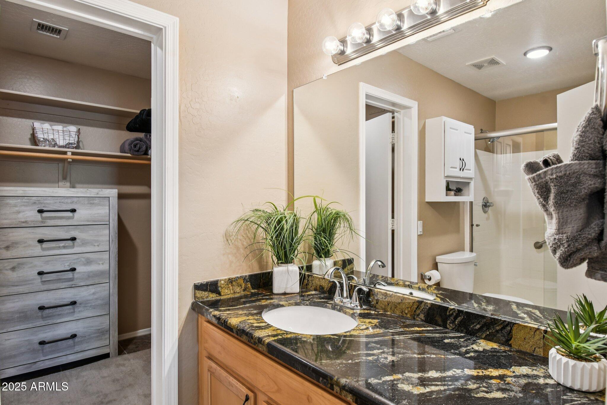 2250 East Deer Valley Drive, Unit 109 Phoenix, AZ 85024 - Photo 7 of 20 a bathroom with a granite countertop sink and a mirror