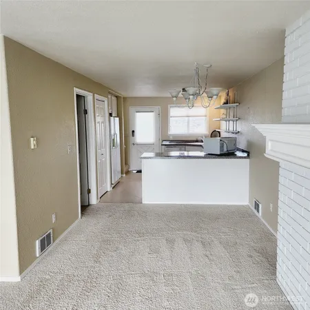 a large white kitchen with cabinets and stainless steel appliances
