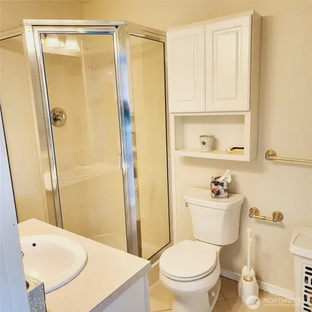 a white toilet sitting next to a bathroom sink