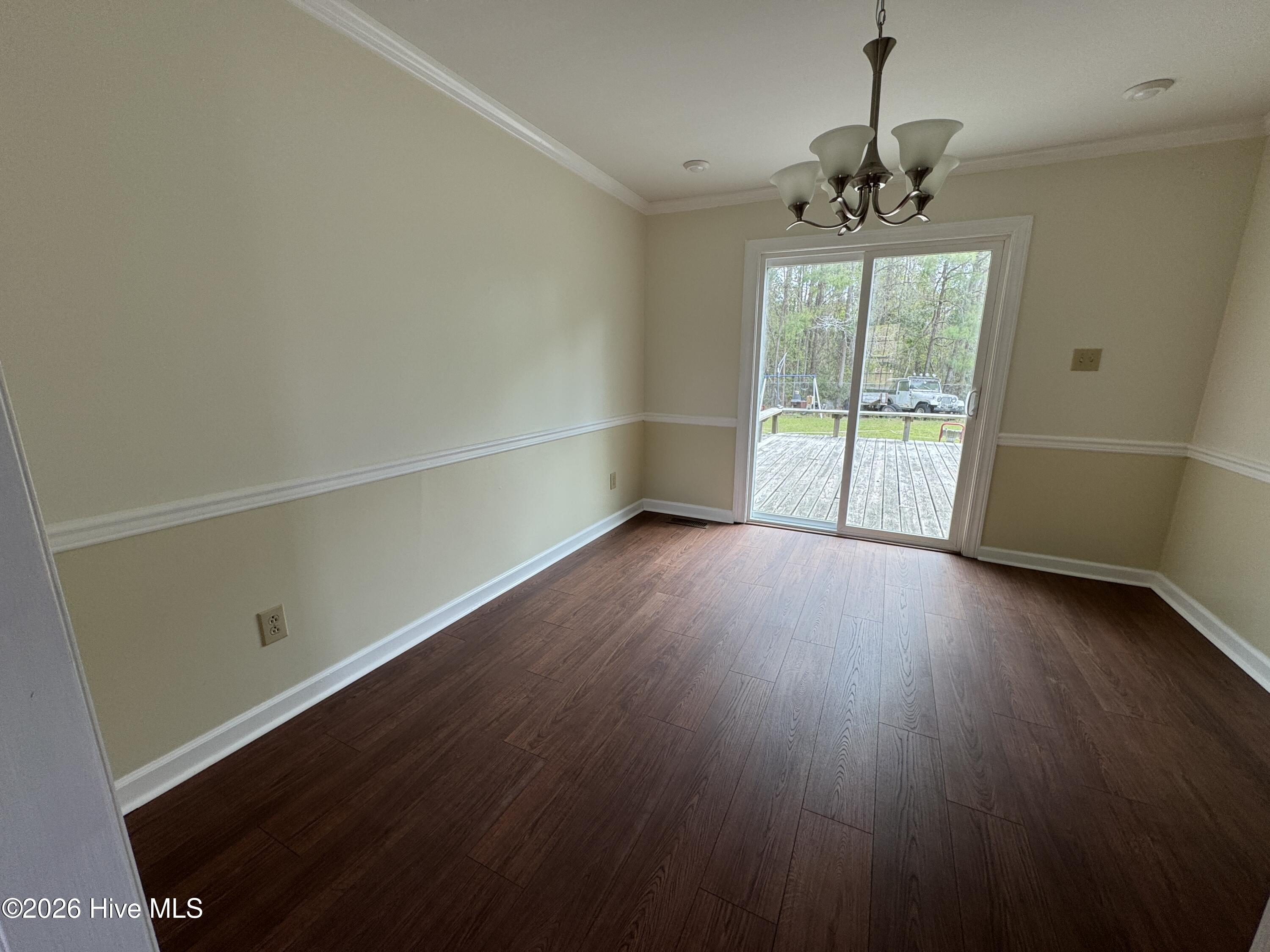 2 Raintree Way Havelock, NC 28532 - Photo 12 of 43 Formal Dining Room w/Chandelier and Pot Lights leads to Large Deck.