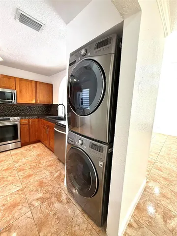 a view of a kitchen with washer and dryer