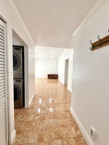 a view of a hallway to a bedroom and a window