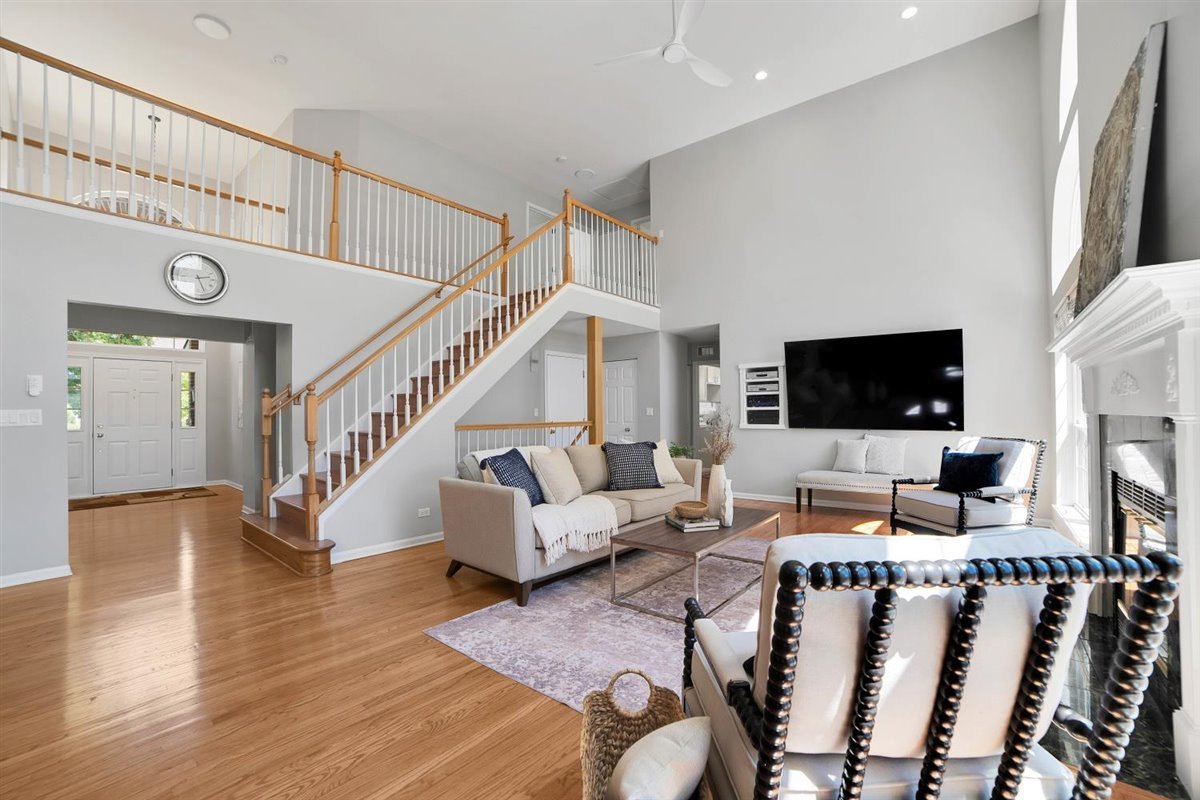 752 Sigmund Road Naperville, IL 60563 - Photo 18 of 55 a living room with furniture wooden floor and a flat screen tv