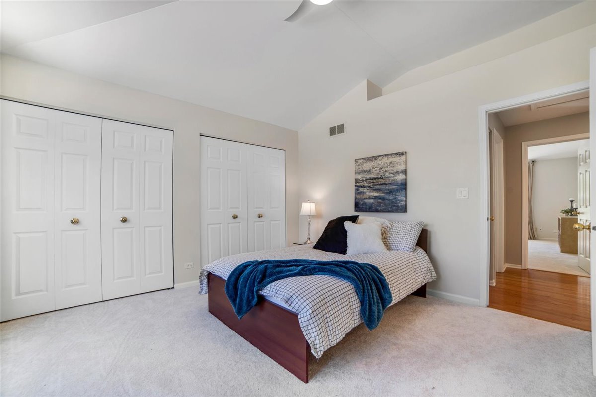 752 Sigmund Road Naperville, IL 60563 - Photo 22 of 55 a bedroom with a bed and lamp