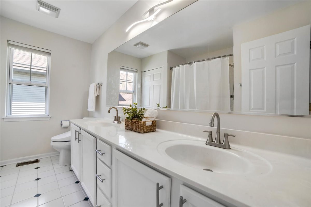 752 Sigmund Road Naperville, IL 60563 - Photo 23 of 55 a bathroom with a sink double vanity and a toilet