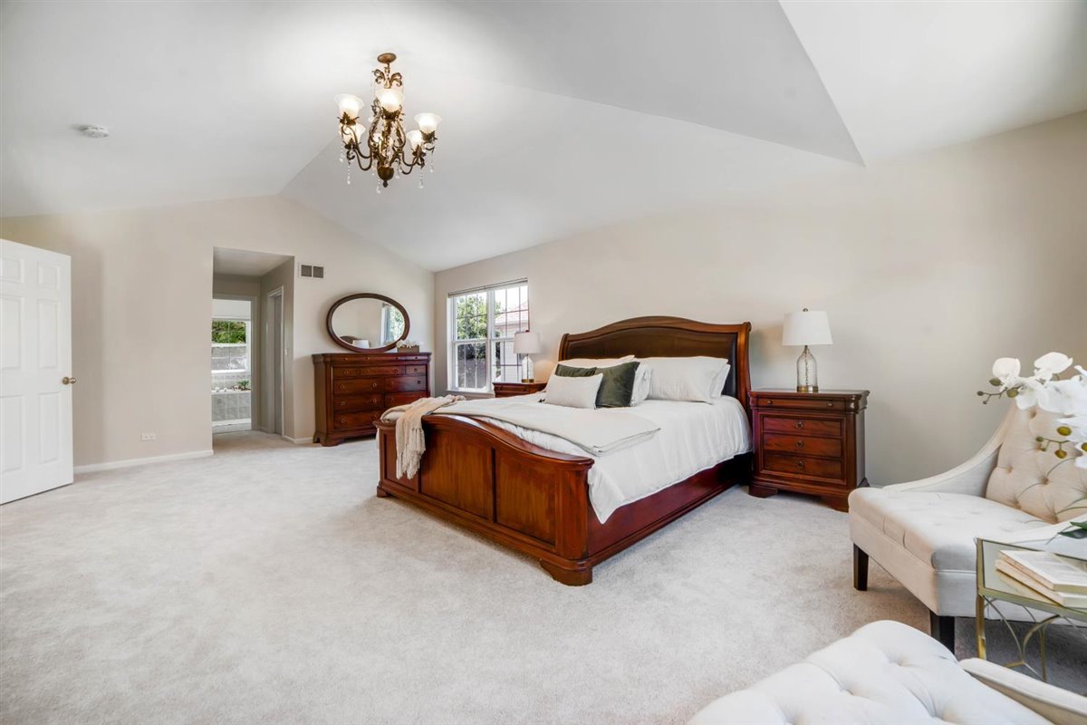 752 Sigmund Road Naperville, IL 60563 - Photo 29 of 55 a bedroom with a bed and a chandelier