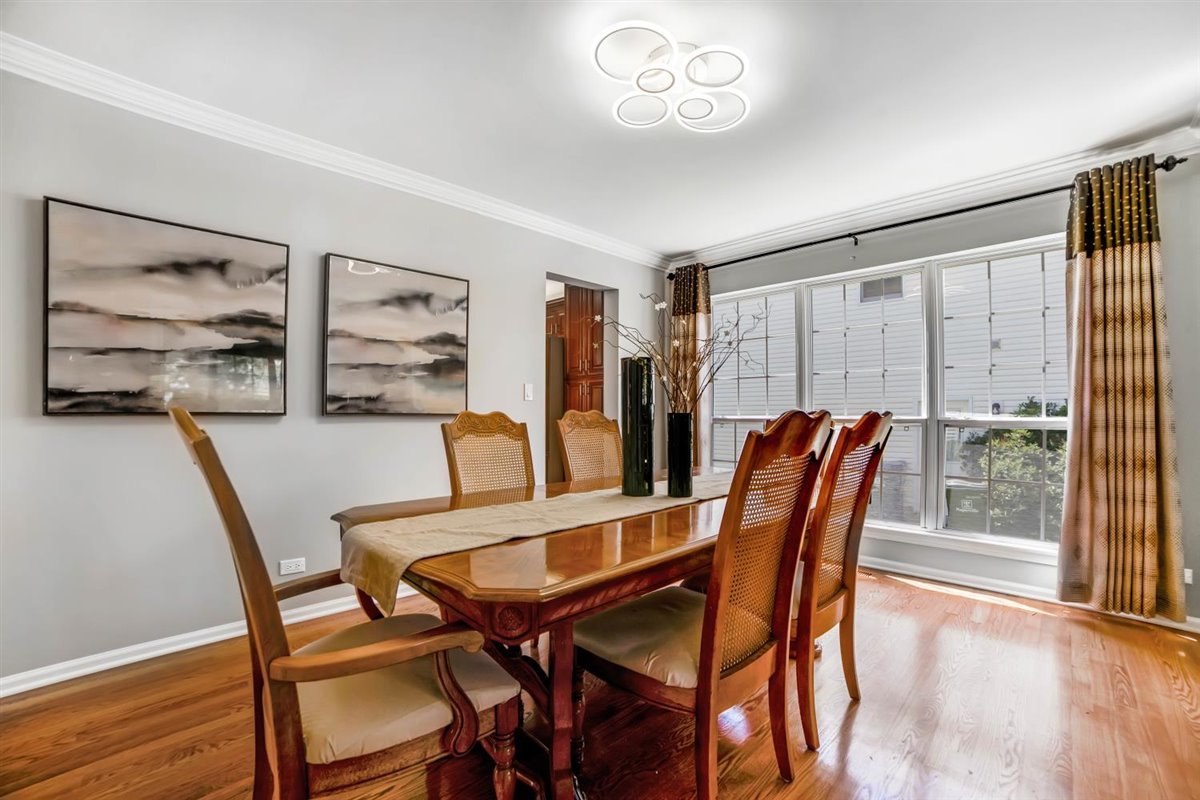 752 Sigmund Road Naperville, IL 60563 - Photo 8 of 55 a view of a dining room with furniture and wooden floor