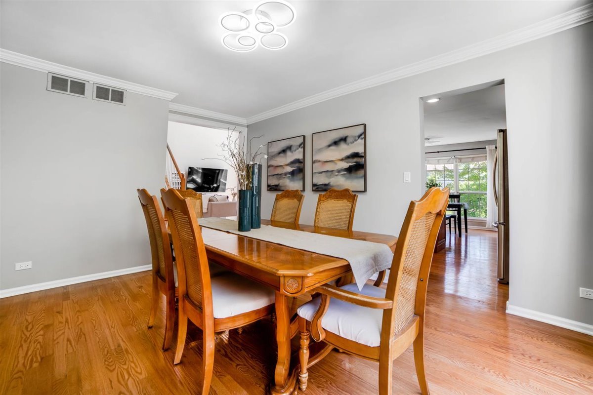 752 Sigmund Road Naperville, IL 60563 - Photo 9 of 55 a dining room with furniture and wooden floor