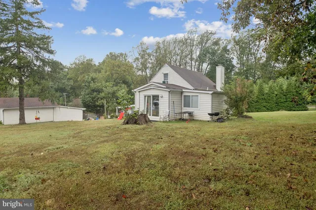 a view of a yard with large trees