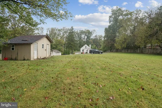 a view of a backyard with large trees