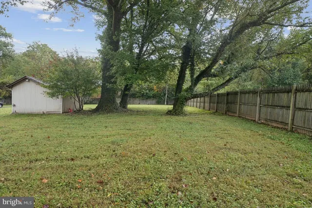 a view of a house with a yard and sitting area