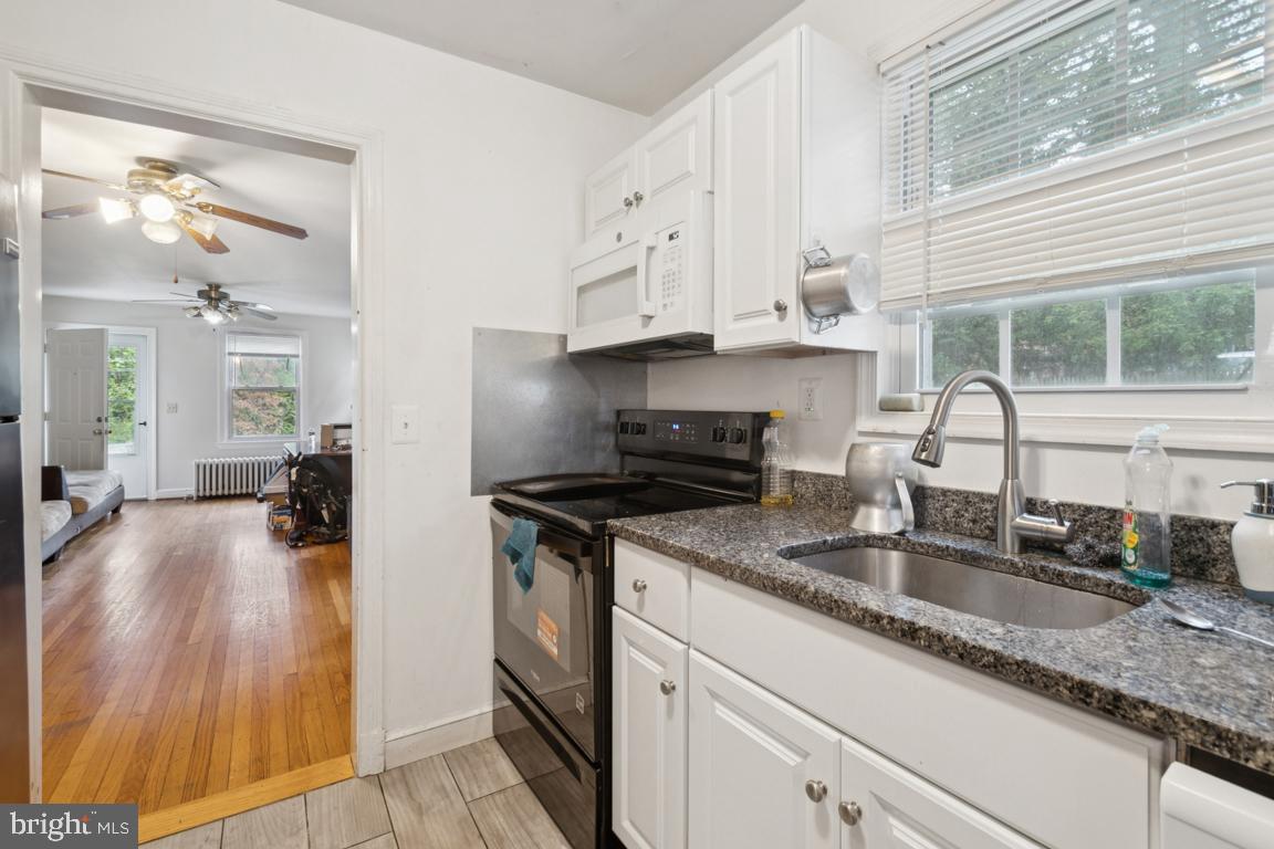 2025 Fairland Road Silver Spring, MD 20904 - Photo 6 of 23 a kitchen with granite countertop a sink stainless steel appliances and cabinets
