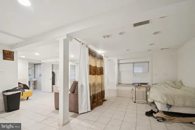 a living room with furniture and a glass door shower