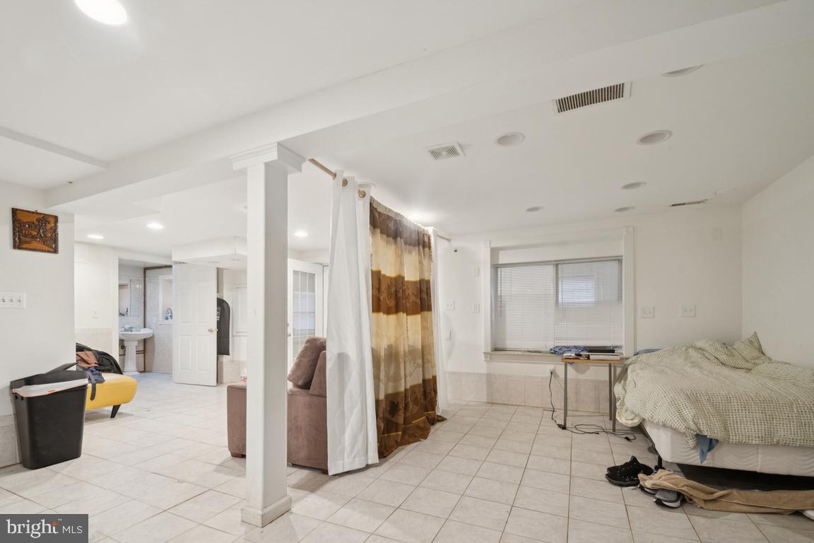 2025 Fairland Road Silver Spring, MD 20904 - Photo 10 of 23 a spacious bedroom with a bed and walk in closet