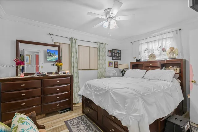 a bedroom with a bed and a mirror on dresser