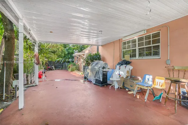 a backyard of a house with table and chairs