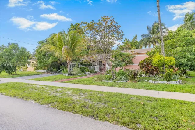 a view of a park and trees in the background